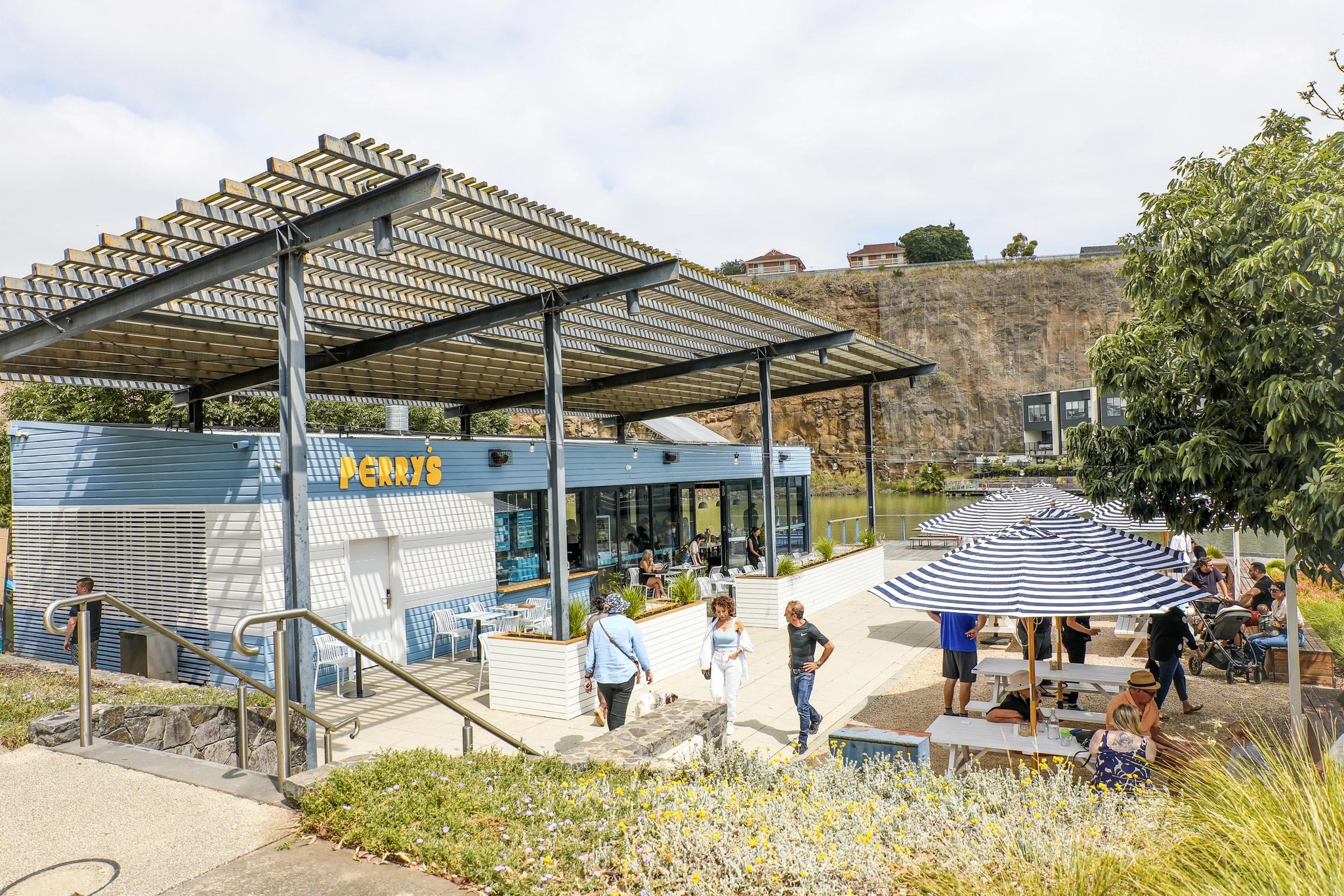 The Perry's pavilion and striped umbrellas beneath the quarry cliff at Valley Lake