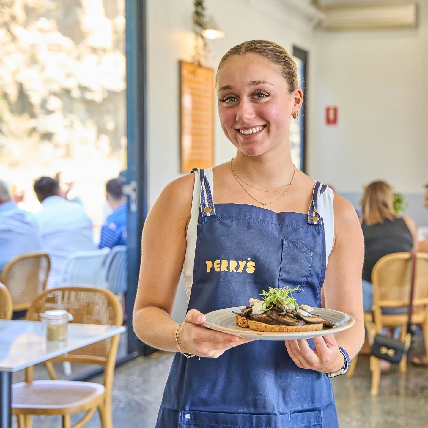 A Perry's team member holding a plate